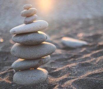 stack of stones on brown sand